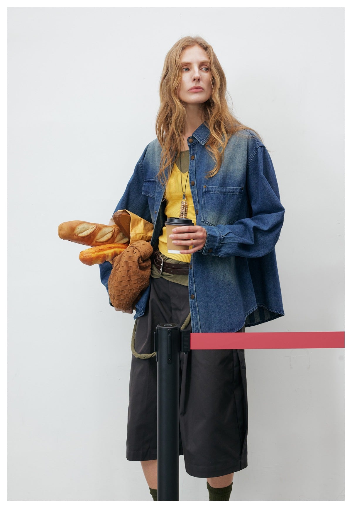 Model in a blue denim button-up shirt, shown from the front with the collar and chest pockets visible.