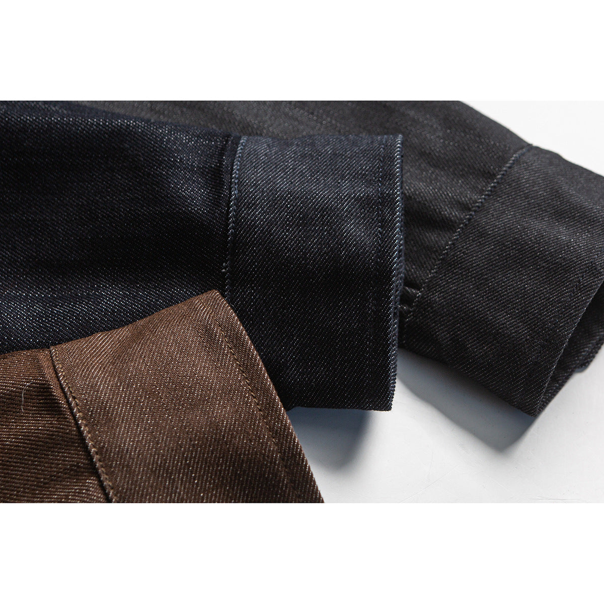 Close-up of folded dark navy and brown shirt fabric showing the weave and edges.