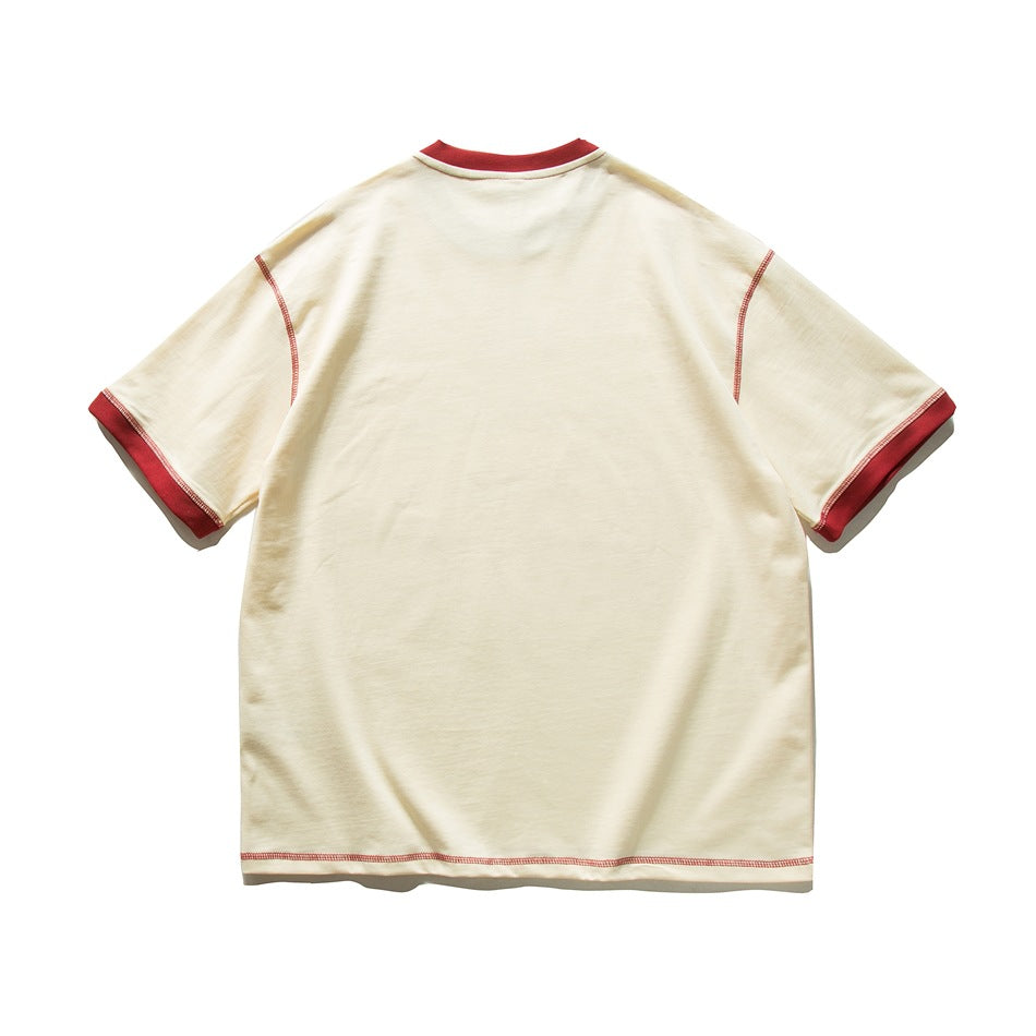 Back view of apricot T-shirt with red ribbed collar, red cuffs and red contrast topstitching, no print