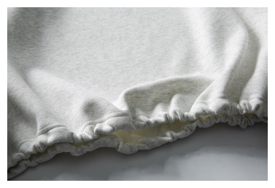 Close-up of a light gray heather garment with a gathered, elasticized edge.