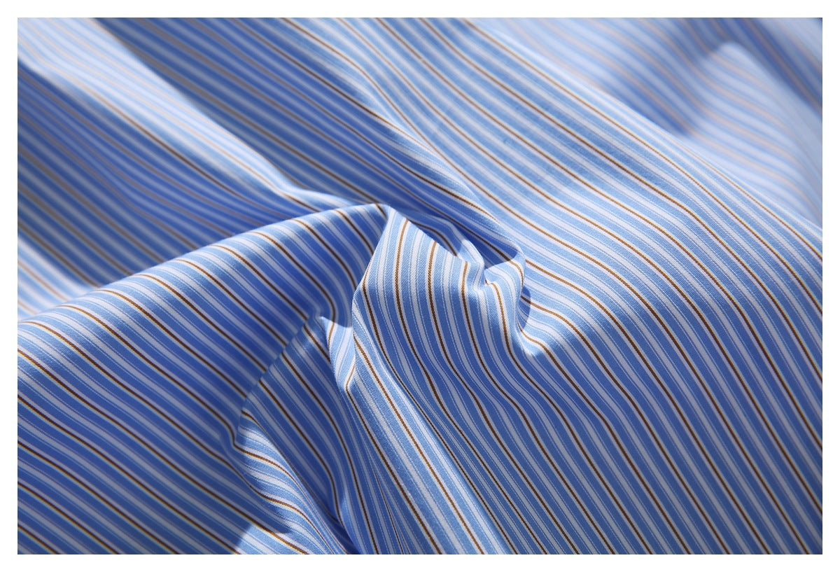 Close-up of draped blue, white, and tan striped shirt fabric.