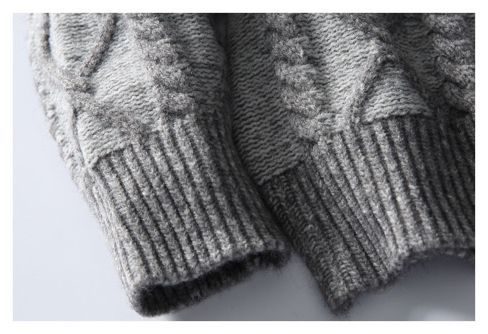 Close-up of the gray sweater's ribbed sleeve cuffs and raised knit pattern.