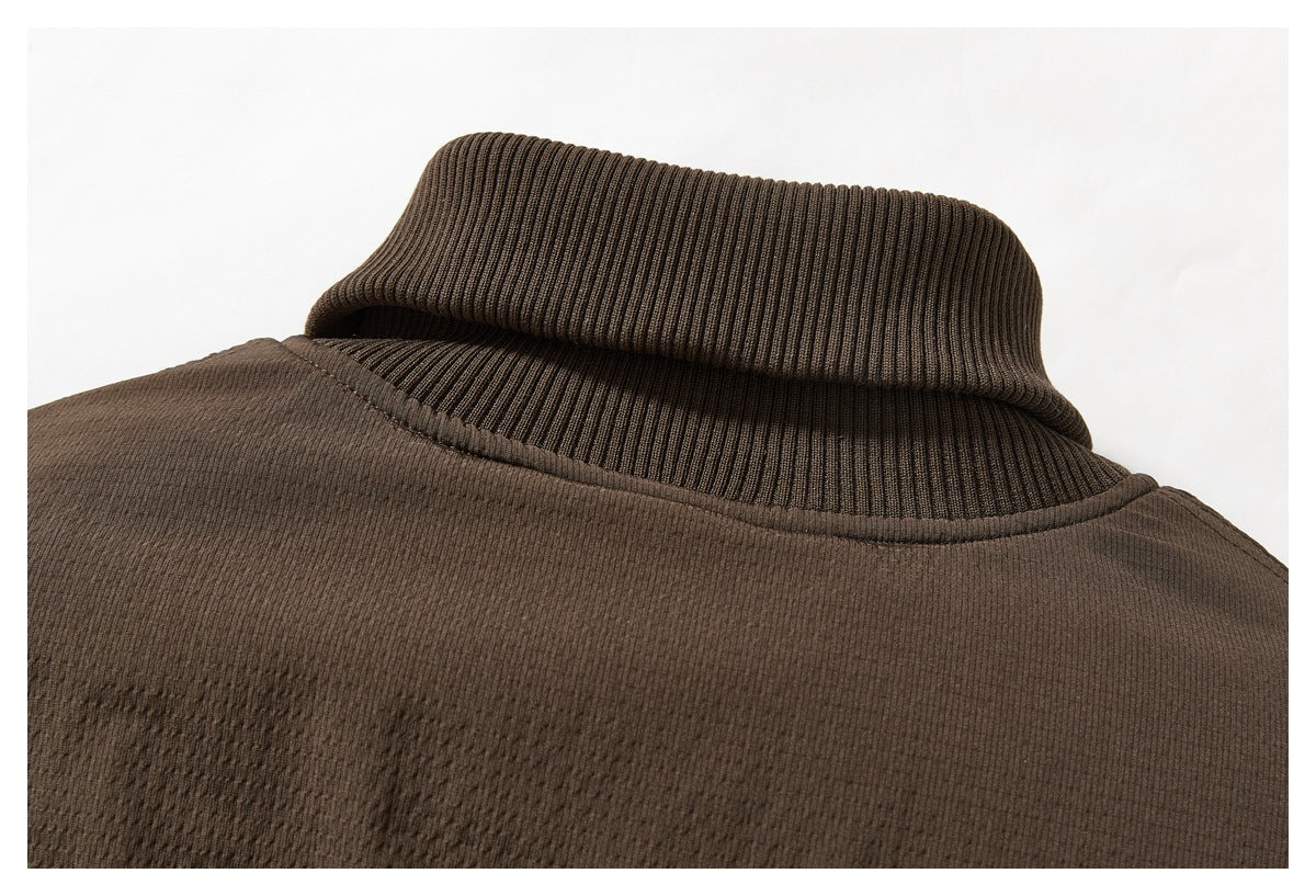 Close-up of the dark brown jacket's ribbed stand collar and upper back seam.