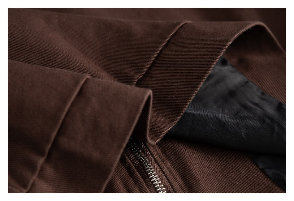 Close-up of a dark brown jacket cuff, zipper, and black inner lining.