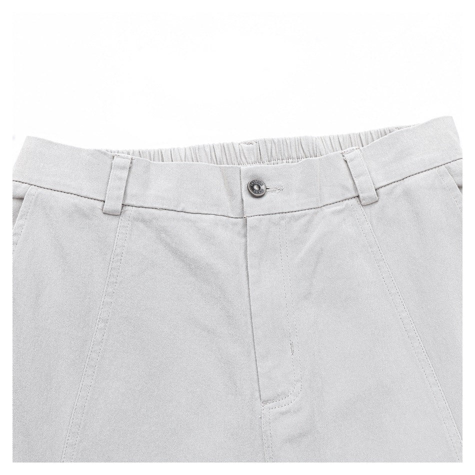 Close-up of the light gray trousers' front waistband, button, belt loops, and fly stitching.