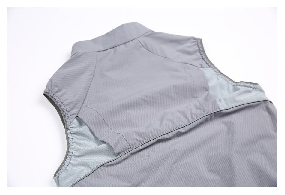 Back view of a gray sleeveless vest laid flat, with light contrasting panels beneath the armholes.