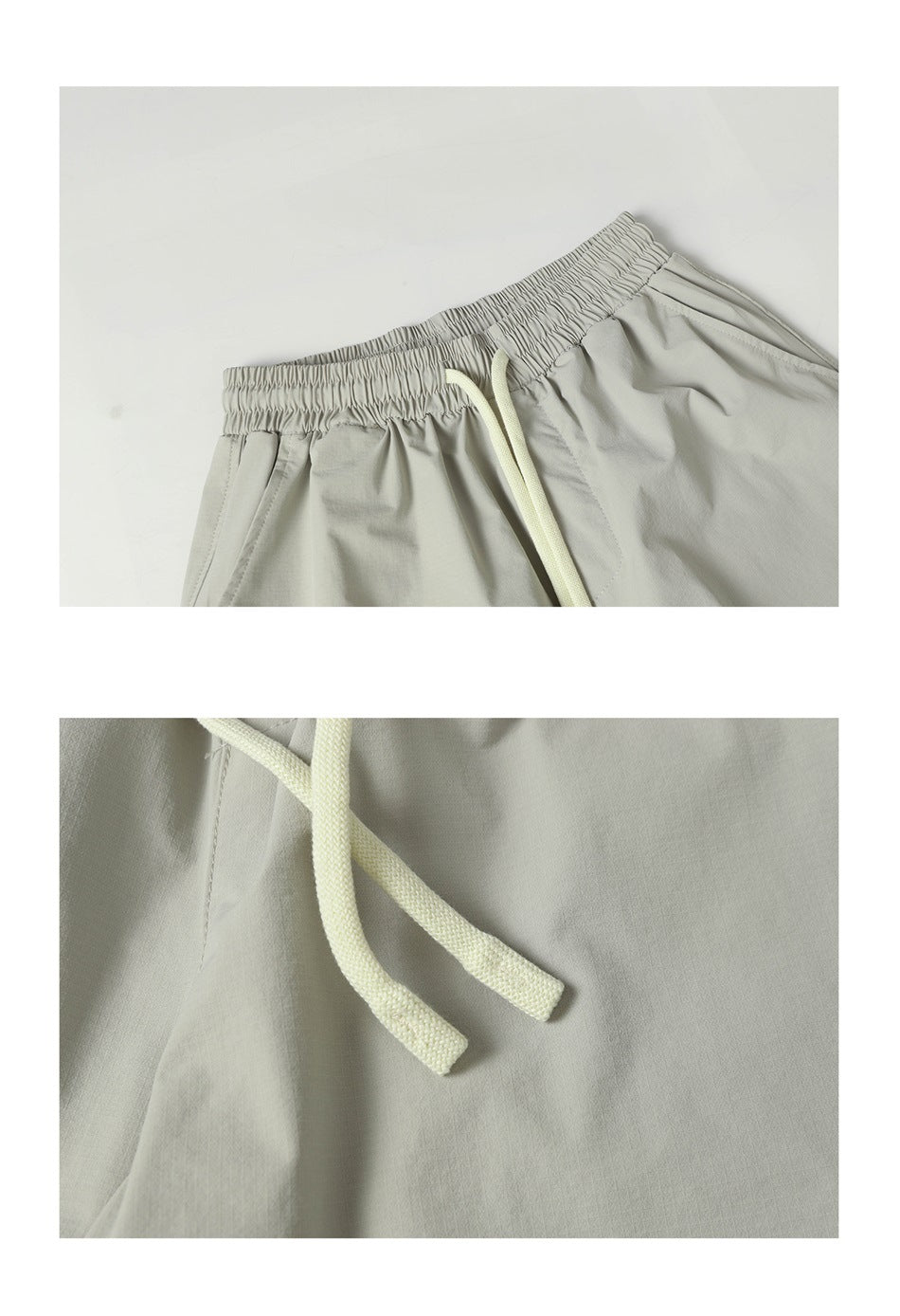 Close-up of light gray trousers showing the gathered elastic waistband, cream drawstring, and front pocket seam.