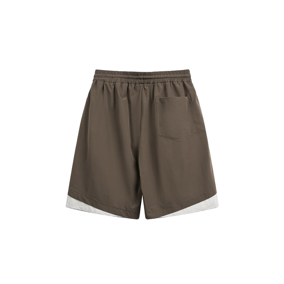 Brown shorts back view with elastic waistband, patch pocket and off-white curved hem panels