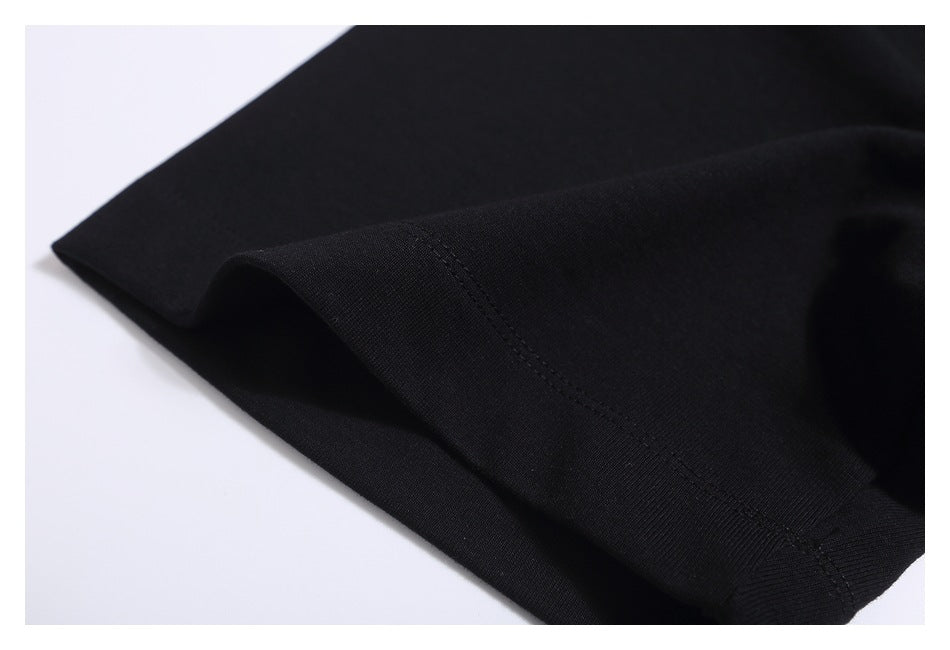 Close-up of the black T-shirt’s sleeve hem and stitching.