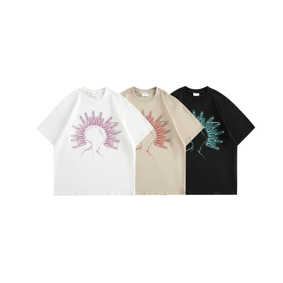 White, beige, and black short-sleeve T-shirts with radiating graphics and metal studs shown from the front.
