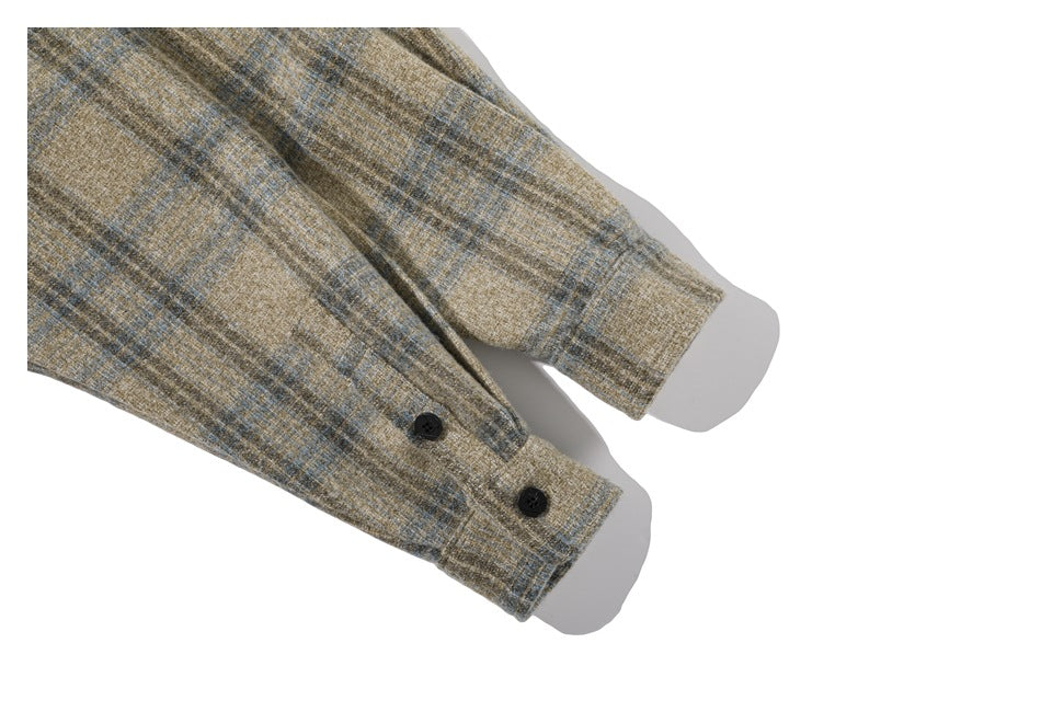 Close-up of two buttoned cuffs on a beige and gray plaid garment against a white background.