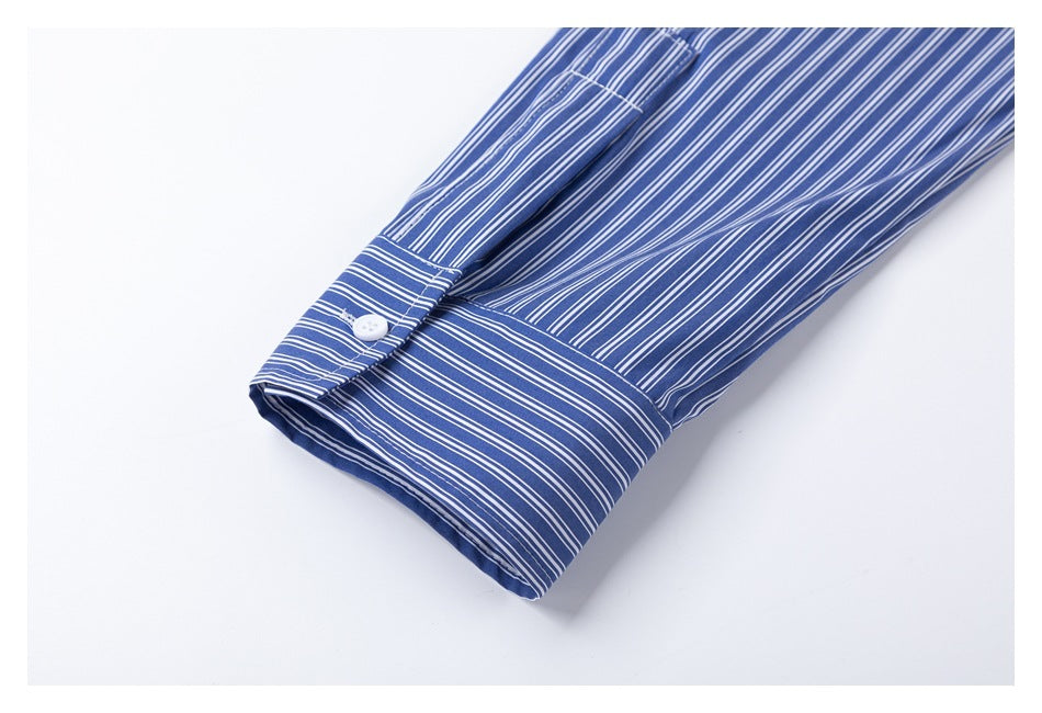 Close-up of a blue-and-white striped sleeve cuff with a white button.