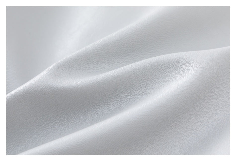 Close-up of the pale gray jacket's fine pebbled surface texture and folded material.