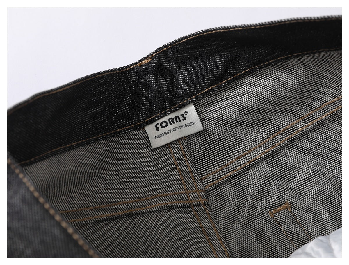 Inside waistband of black jeans with a sewn-in brand label and visible denim weave.