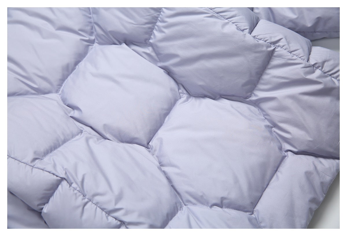 Close-up of the pale lavender jacket's large padded quilt sections and stitching.