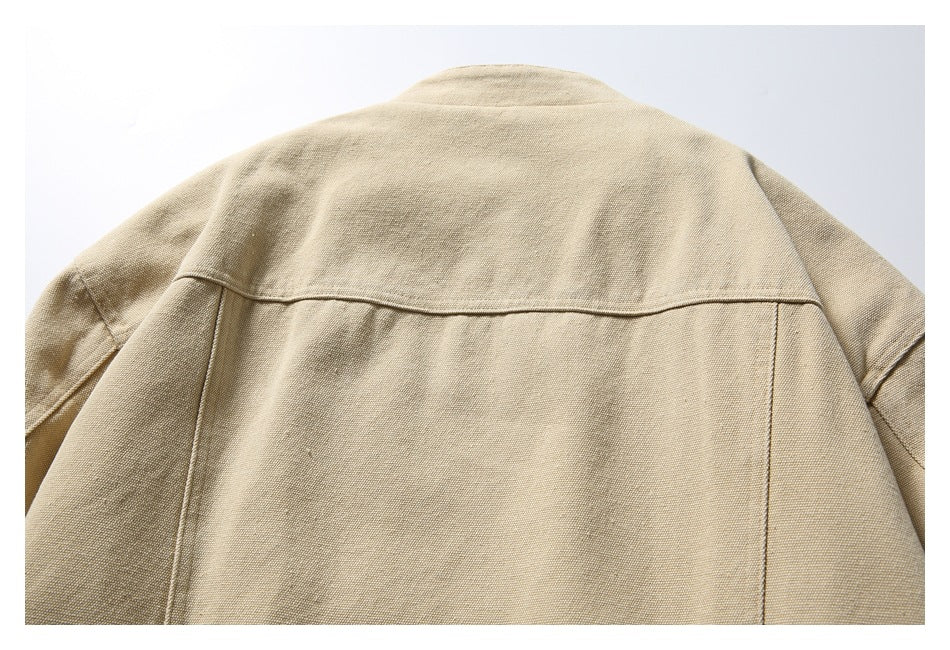Close-up rear view of a beige jacket showing its stand collar and back panel seams.