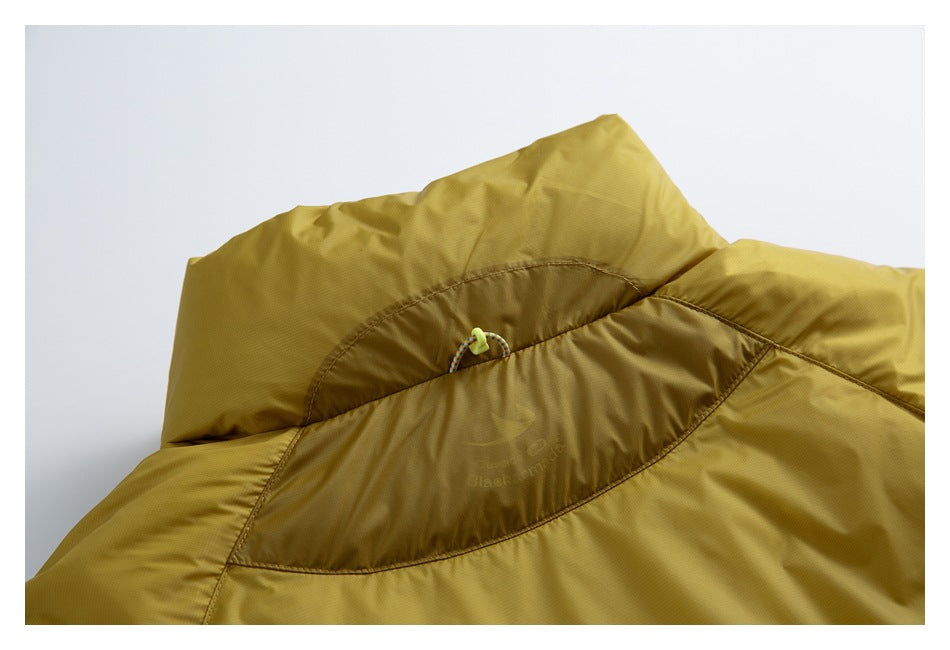 Close-up of a mustard-yellow garment collar with a multicolored cord loop and neon toggle.