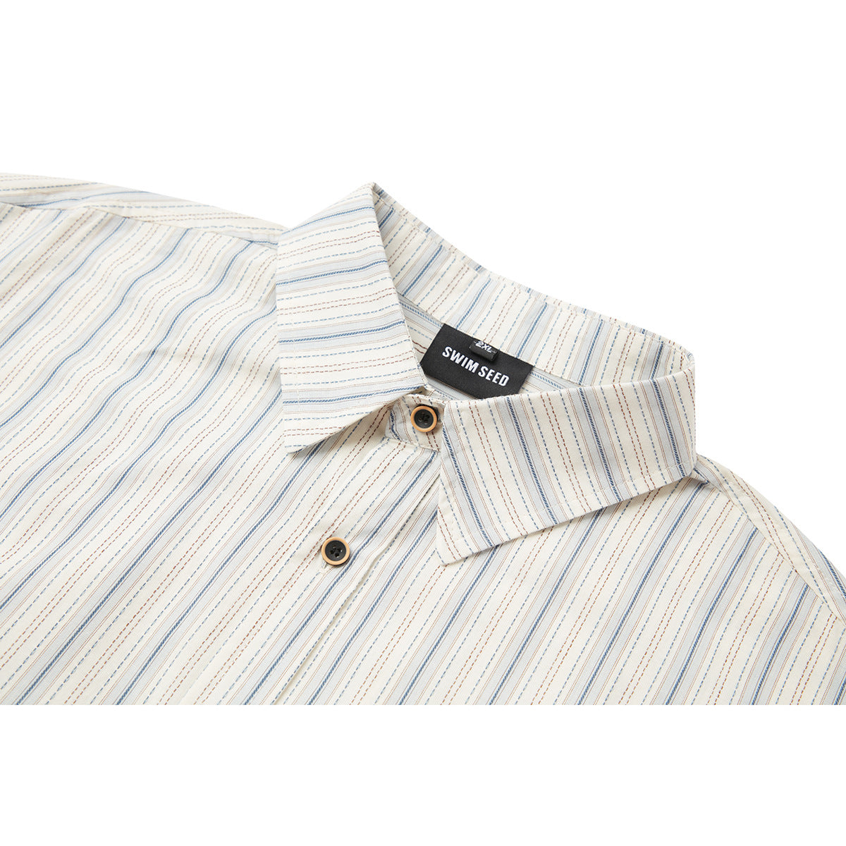 Close-up of an ivory shirt collar and buttons with fine blue and brown stripes and a black neck label.