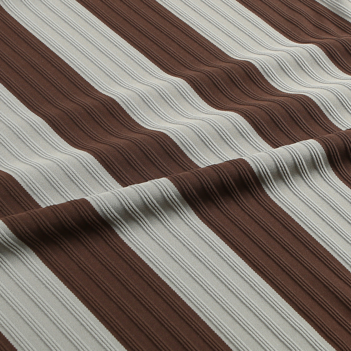 Close-up of the T-shirt's raised horizontal brown and gray stripe texture.