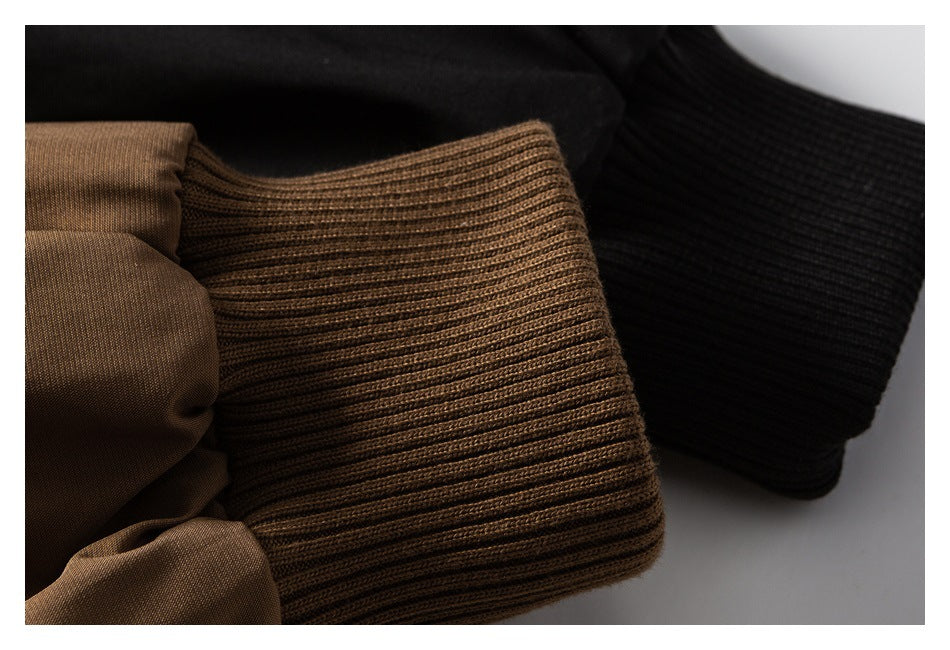 Close-up of brown and black ribbed jacket cuffs beside the smooth jacket fabric.