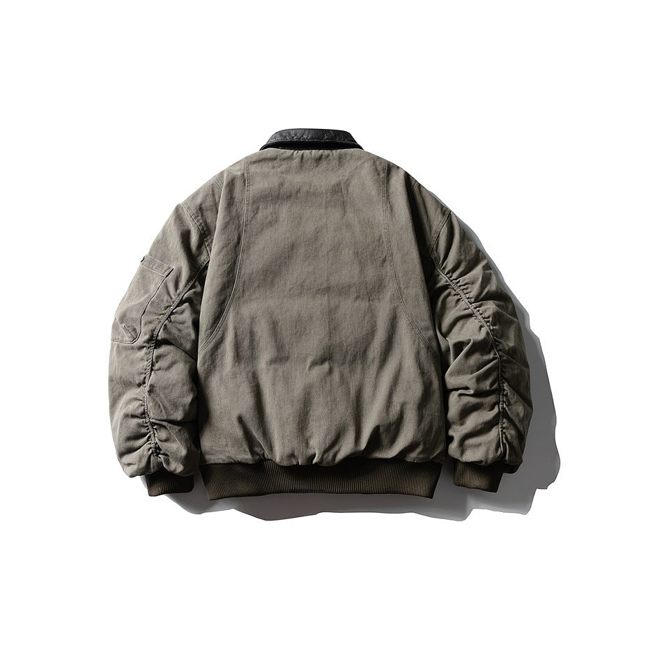 Back view of green padded bomber jacket with dark collar, ruched sleeves and ribbed hem, flat lay