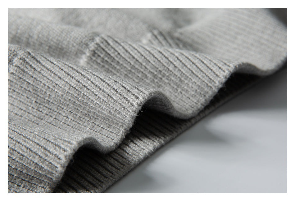 Close-up of gray ribbed knit fabric folded to show its raised edge and texture.