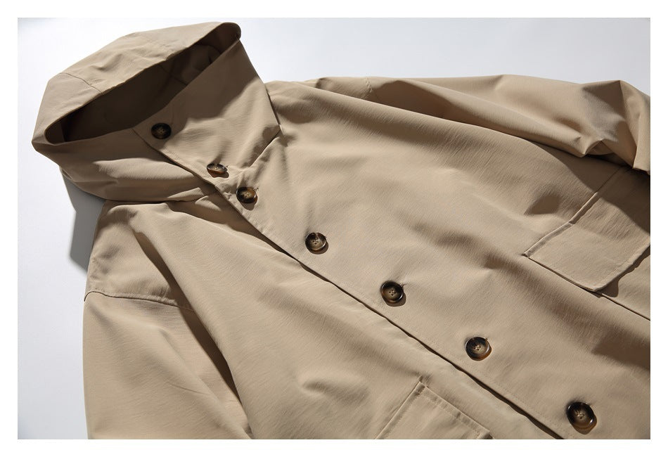 Beige hooded coat shown diagonally from the front, with dark buttons and patch pockets.