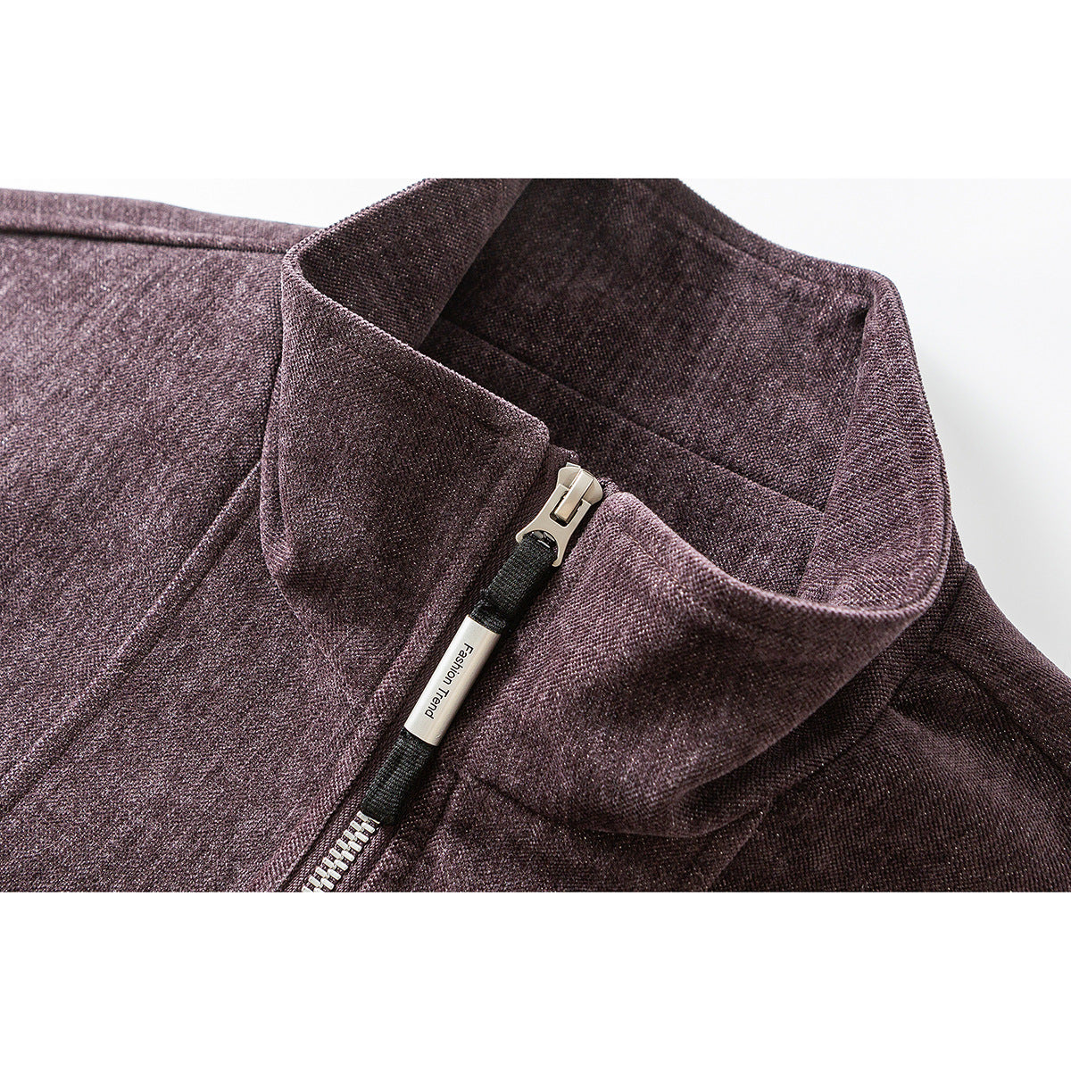 Close-up of a mauve-brown jacket collar and silver front zipper with a small English-text pull tab.