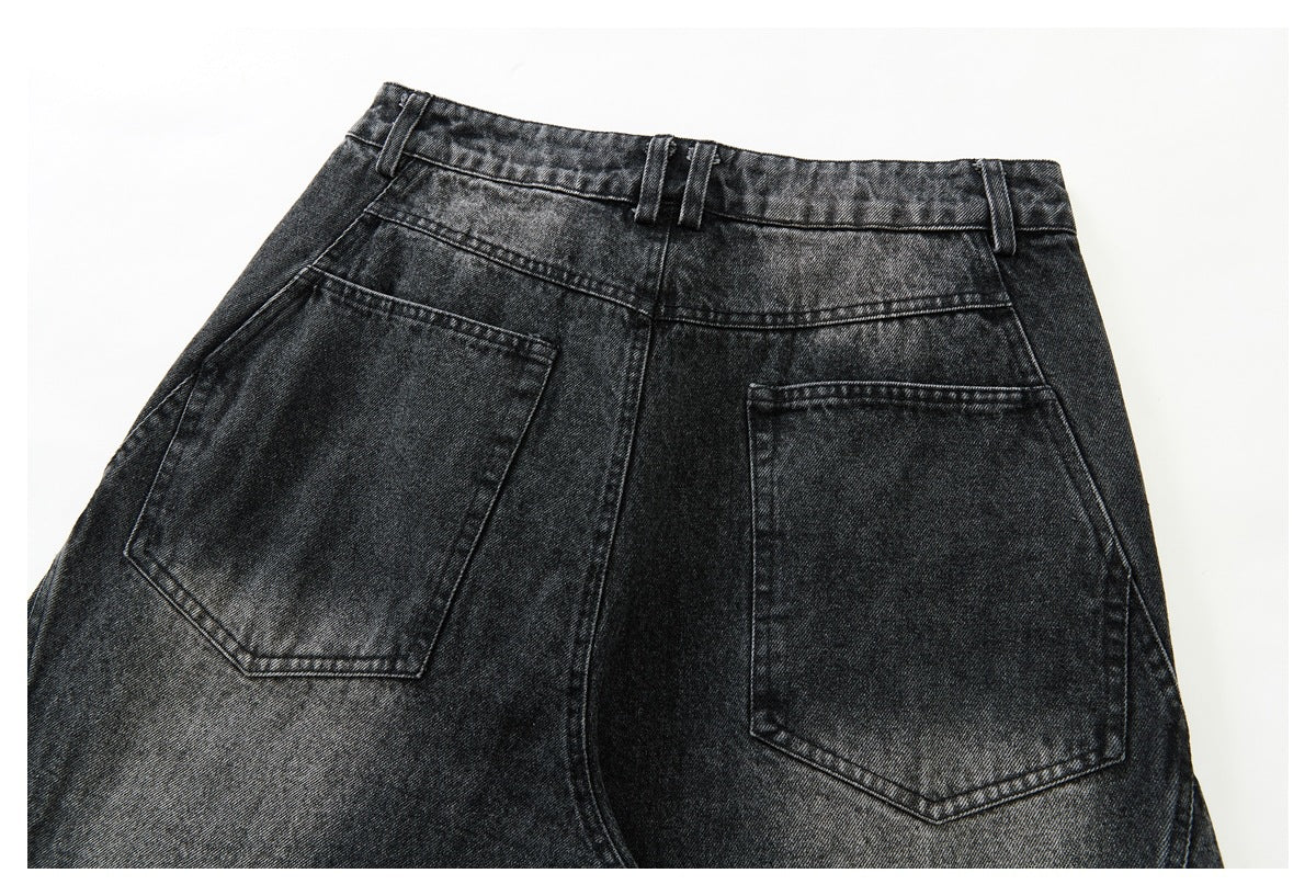 Upper back view of dark charcoal washed jeans with belt loops and two large back pockets.