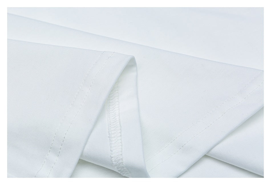 Close-up of white garment fabric showing a folded edge and an overlocked seam.