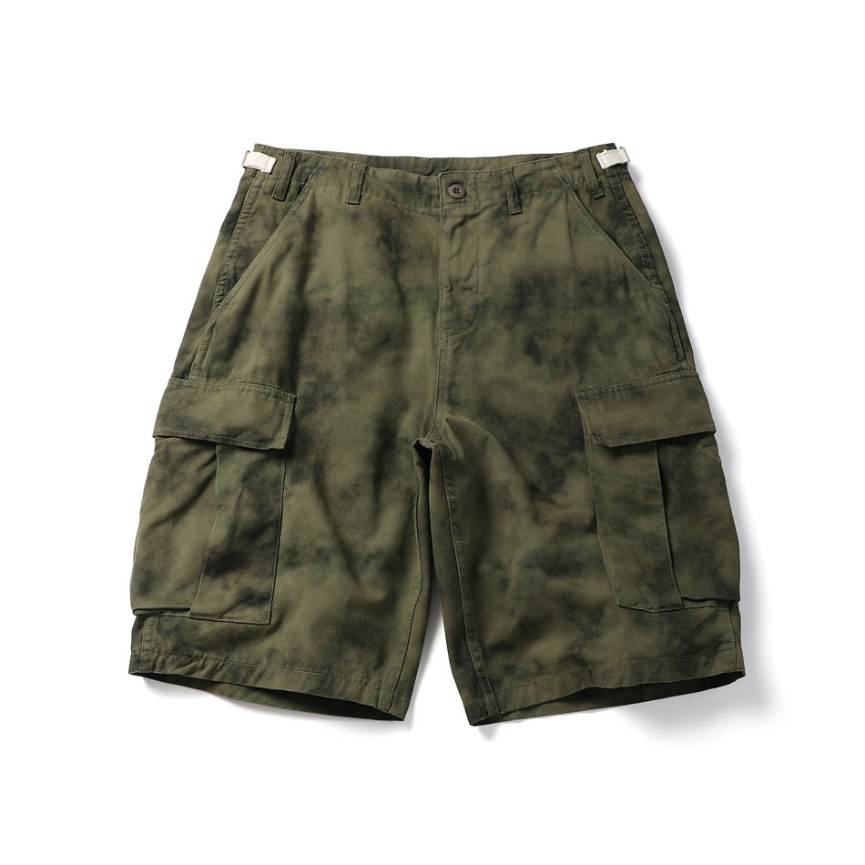 Olive green tie-dye cargo shorts, flat lay front view with button front and flap cargo pockets
