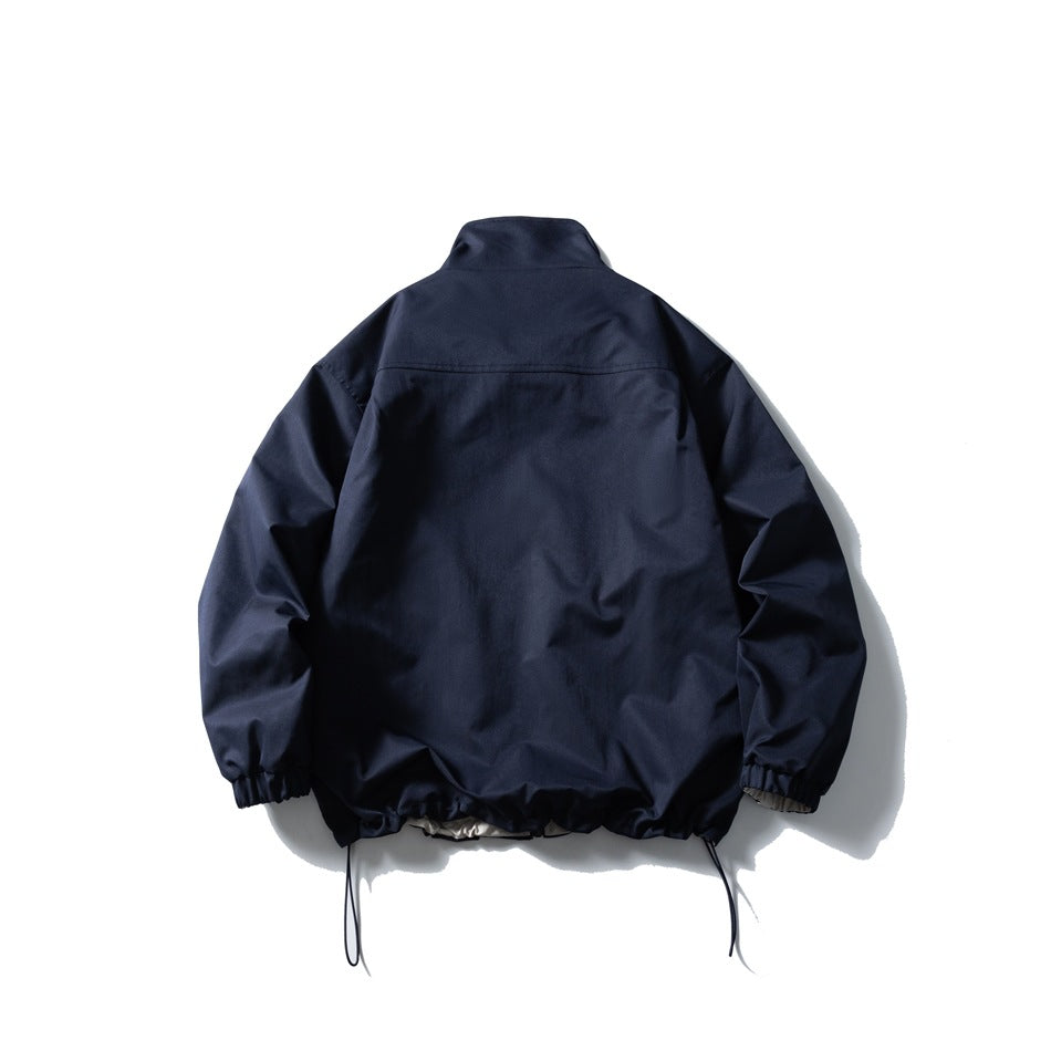 Back view of a navy jacket with a stand collar, gathered cuffs, and adjustable hem drawcords.