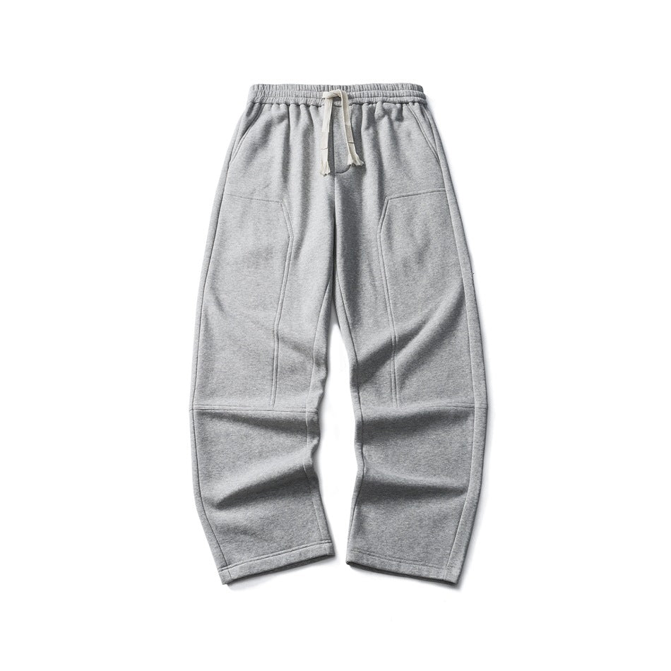 Heather gray drawstring sweatpants laid flat, front view, with wide straight legs and seamed knee panels