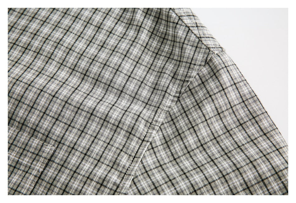 Close-up of the gray plaid shirt's shoulder seam and short sleeve.
