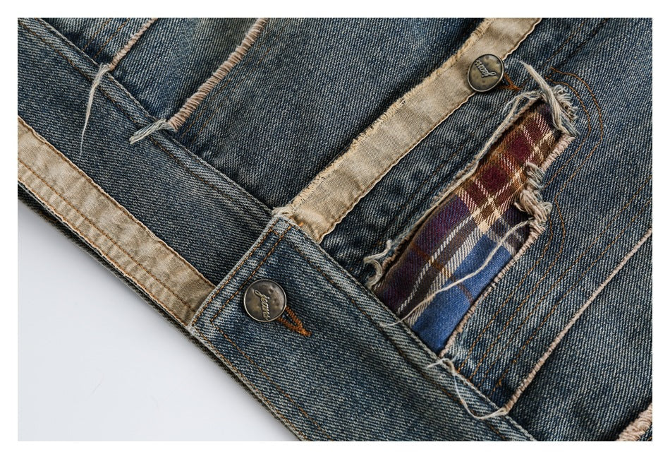 Close-up of blue denim with metal buttons, tan lining, and a frayed pocket opening revealing plaid fabric.
