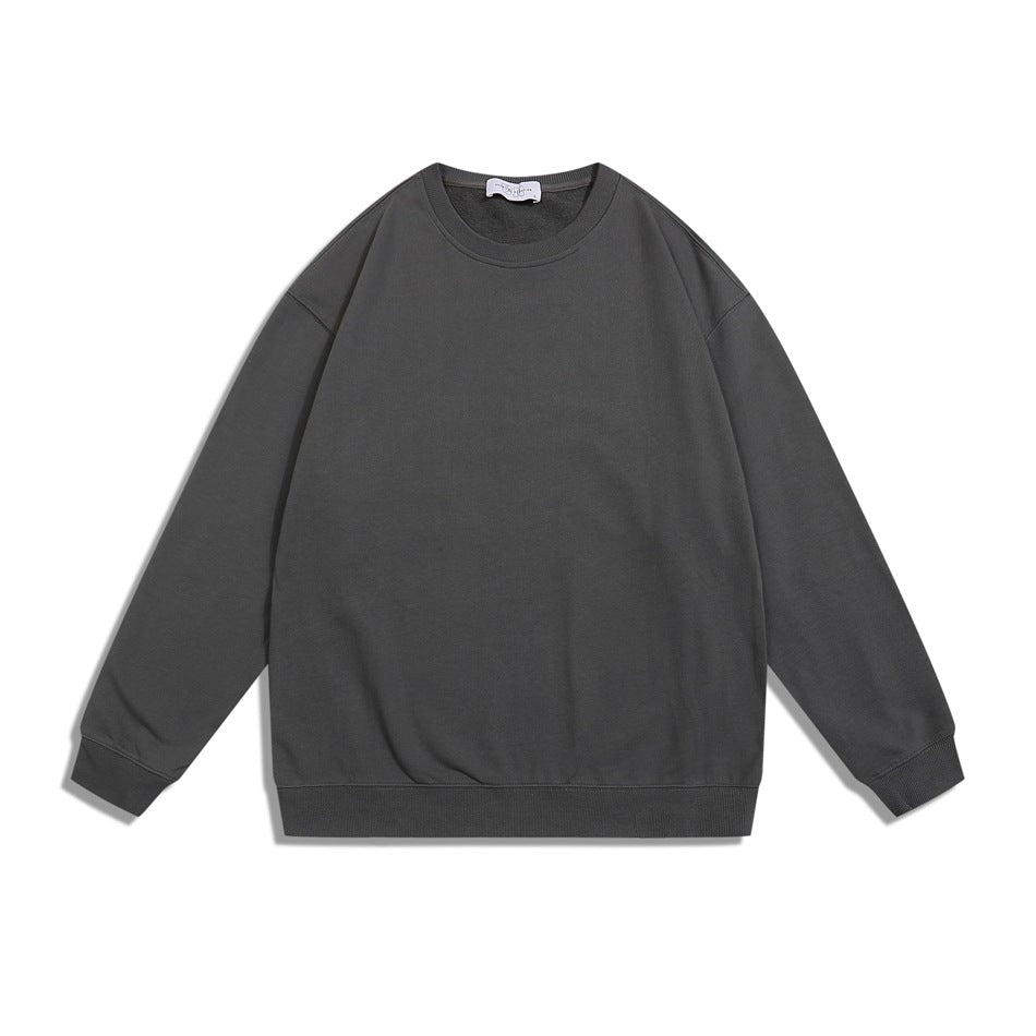 Dark gray crewneck sweatshirt flat lay, front view, with ribbed collar, cuffs and hem