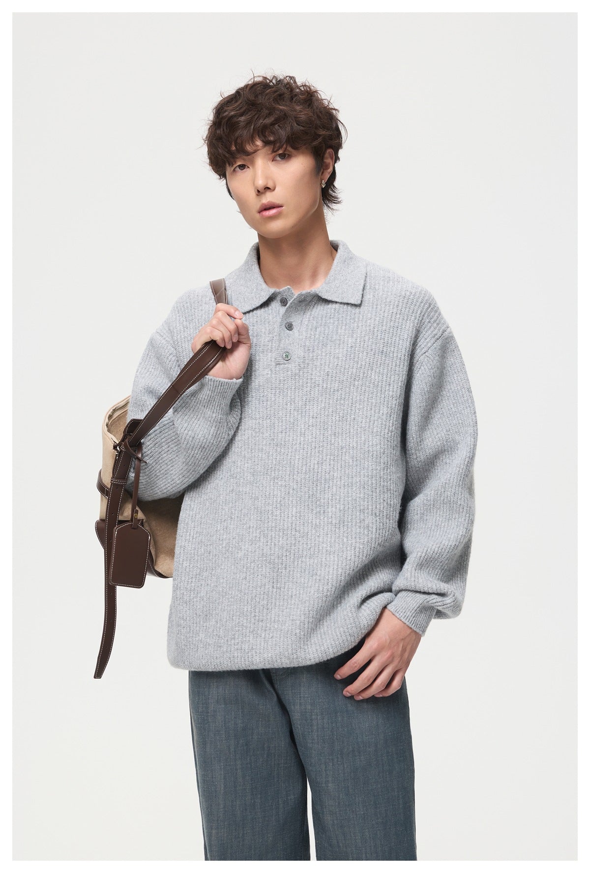 Model wearing a light gray ribbed long-sleeve knit polo with a short button placket and collar.