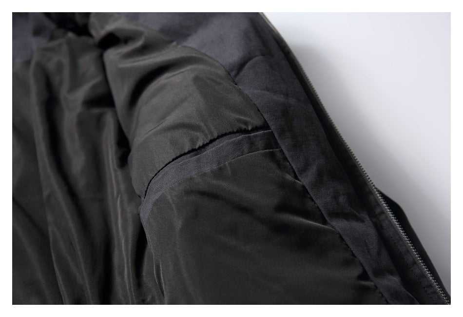 Close-up of the black jacket's interior lining and inner seam near the zipper.