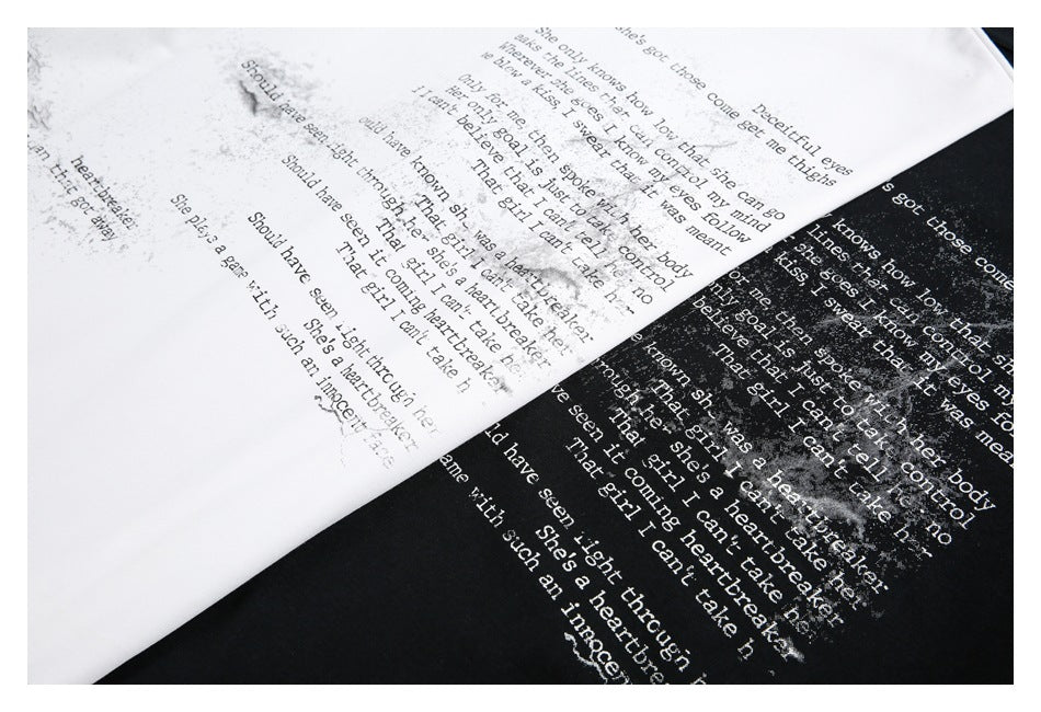 Close-up of English text artwork printed in white on black and black on white fabric.
