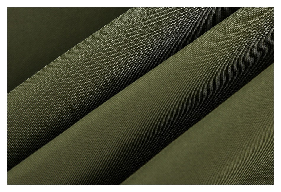 Close-up of olive-green fabric folded to show its fine diagonal weave and texture.