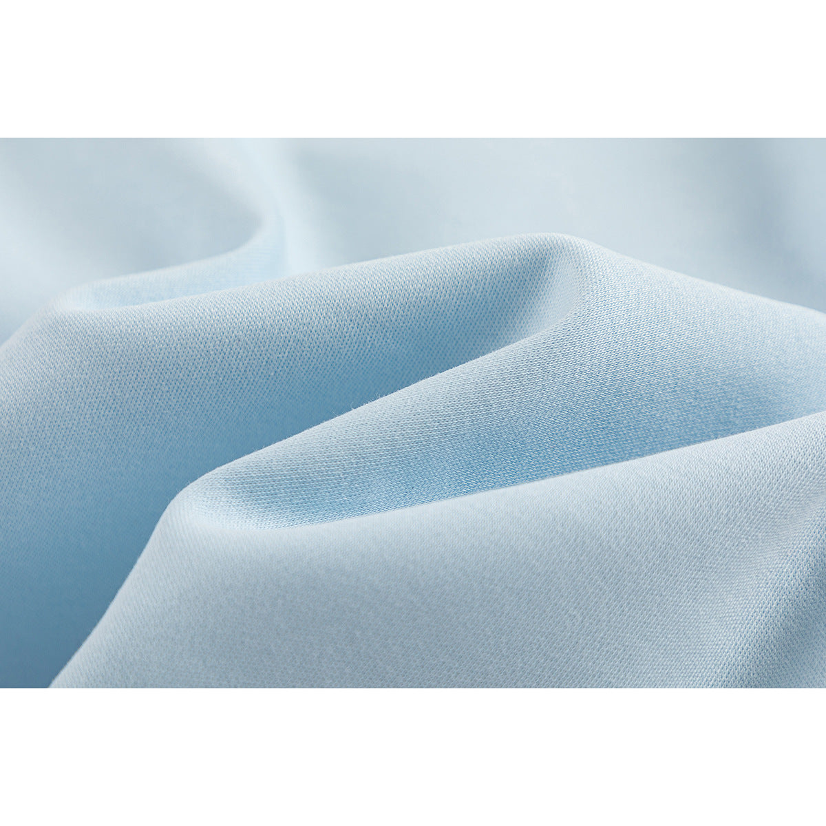 Close-up of light blue fabric draped to show its surface texture.