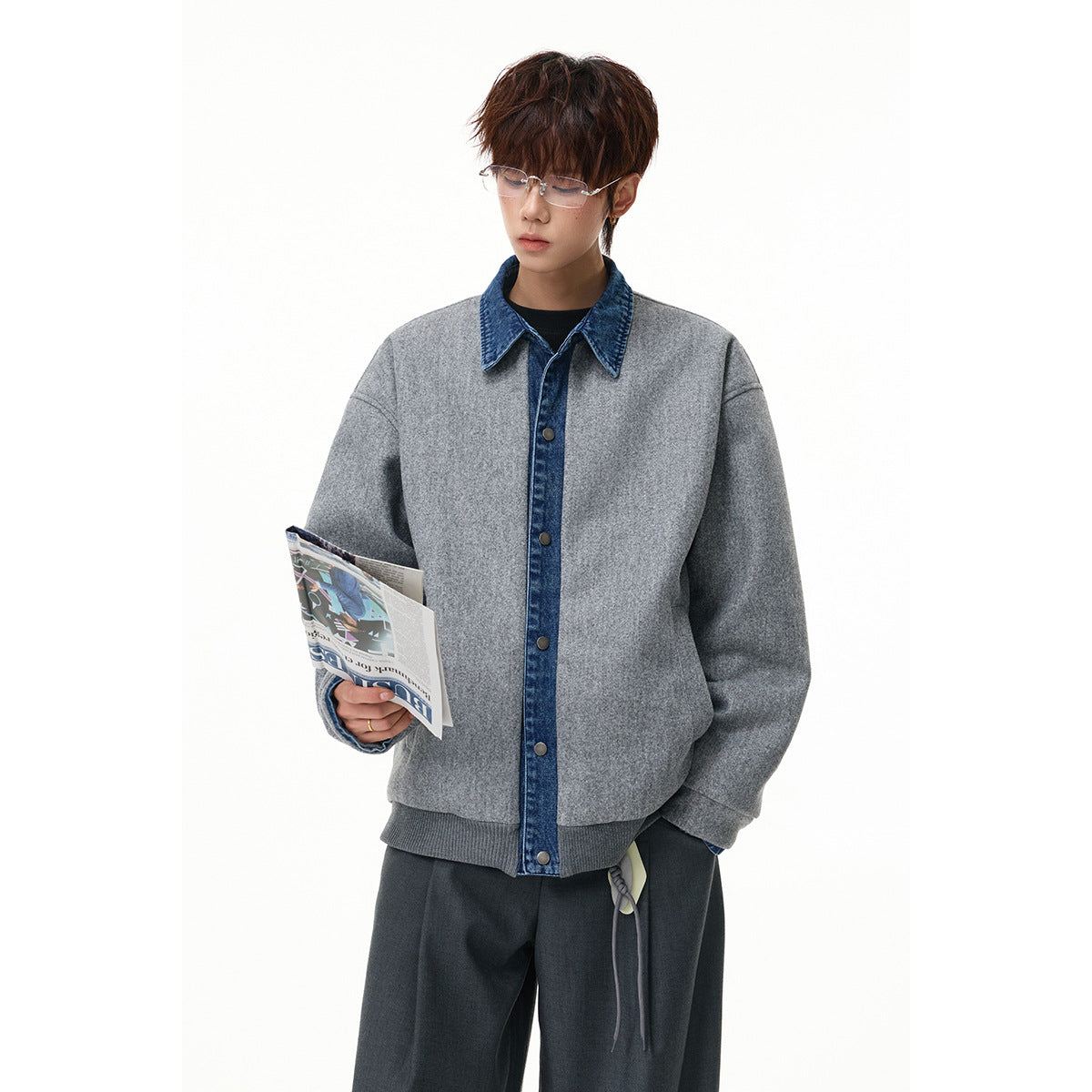 Model wearing a gray jacket with blue denim collar and button placket, ribbed hem, and dark trousers.