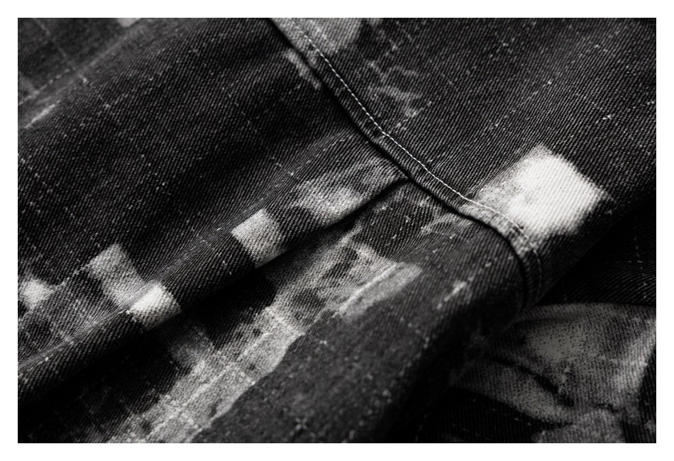Close-up of intersecting seams on black-and-gray abstract-print fabric.