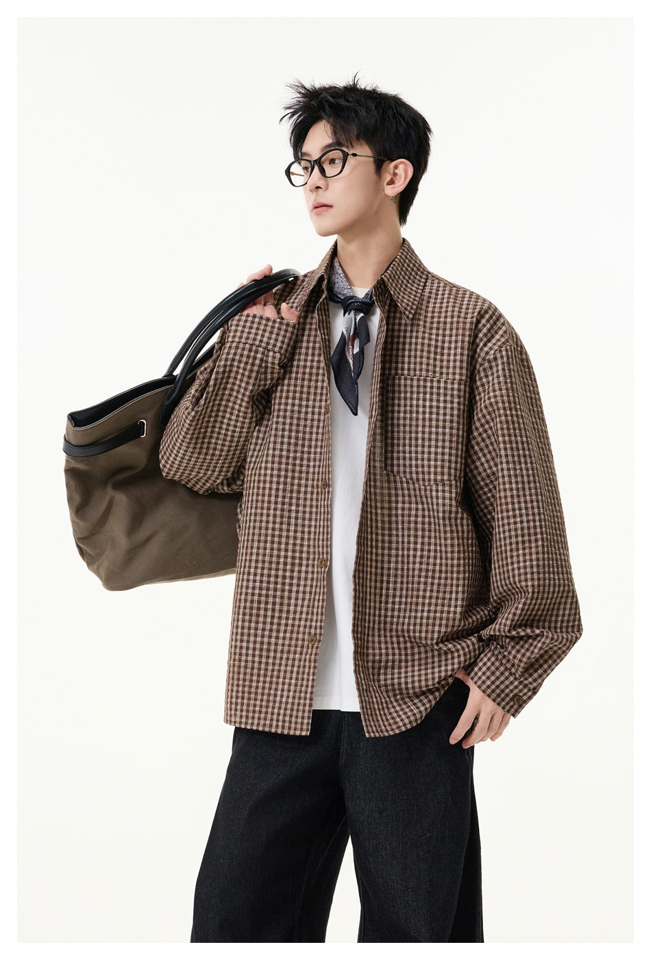 Model wearing an open brown checked button-up shirt with a chest pocket over a white tee.