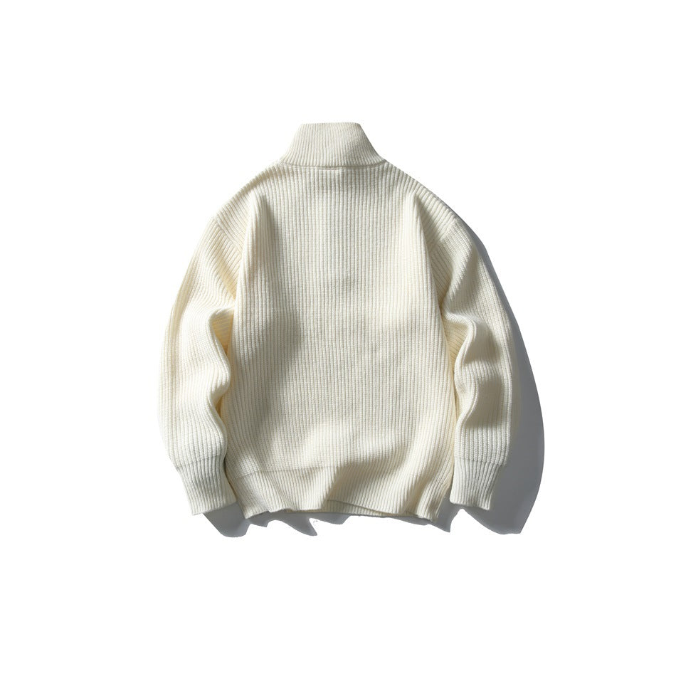 Back view of a cream rib-knit sweater with a high collar, long sleeves, and ribbed trim.