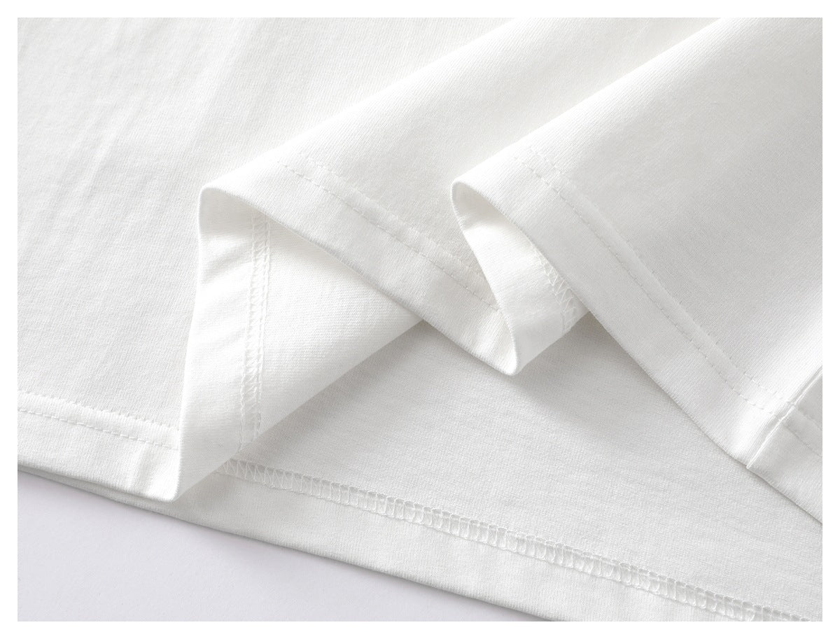 Close-up of the white shirt’s folded hem and visible stitching.