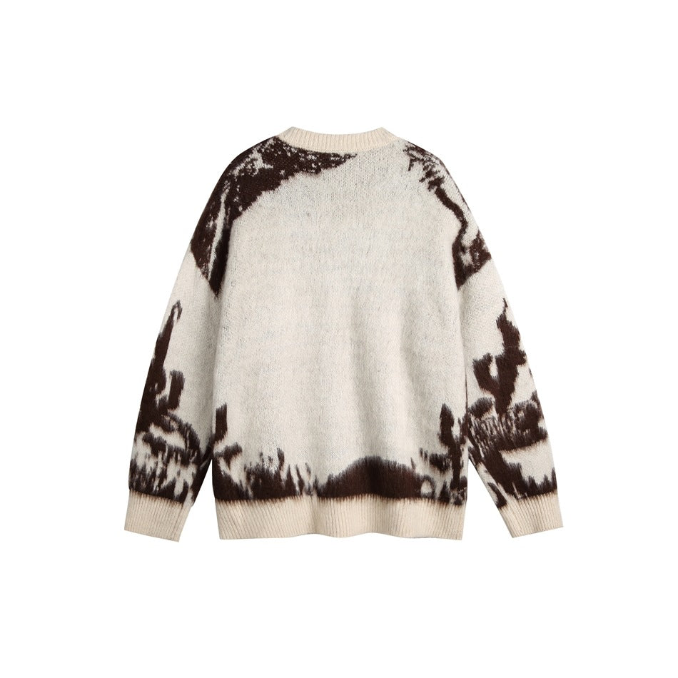 Back view of an ivory crew-neck sweater with dark brown abstract patterning across the shoulders, sleeves, and hem.