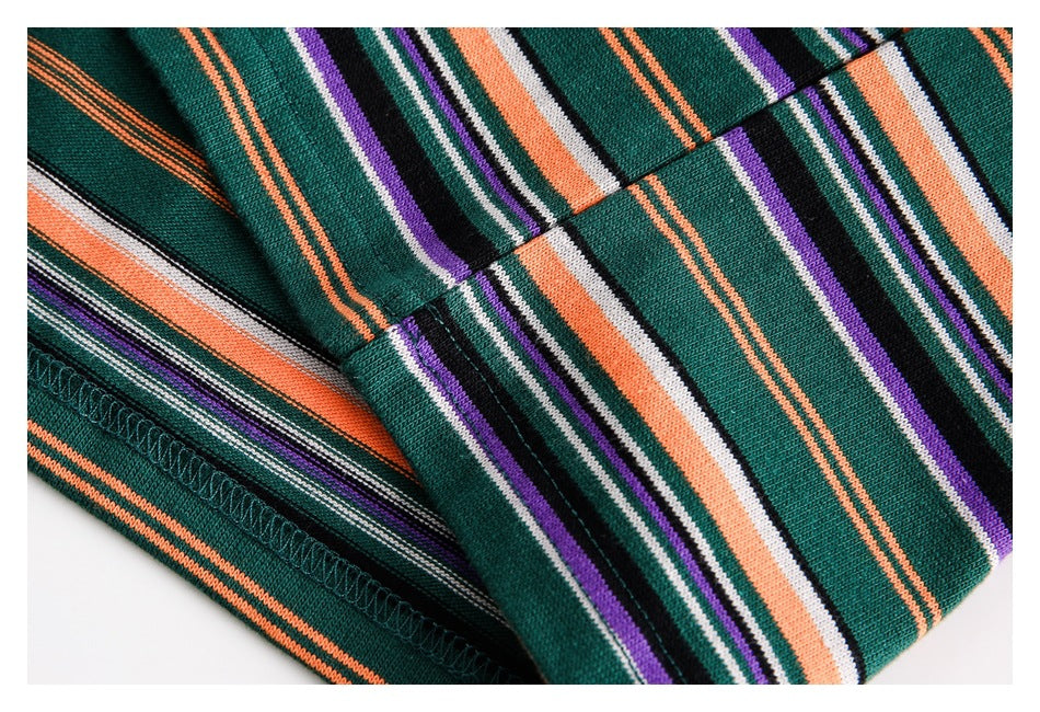 Close-up of the striped knit top's folded sleeve and stitched hem.