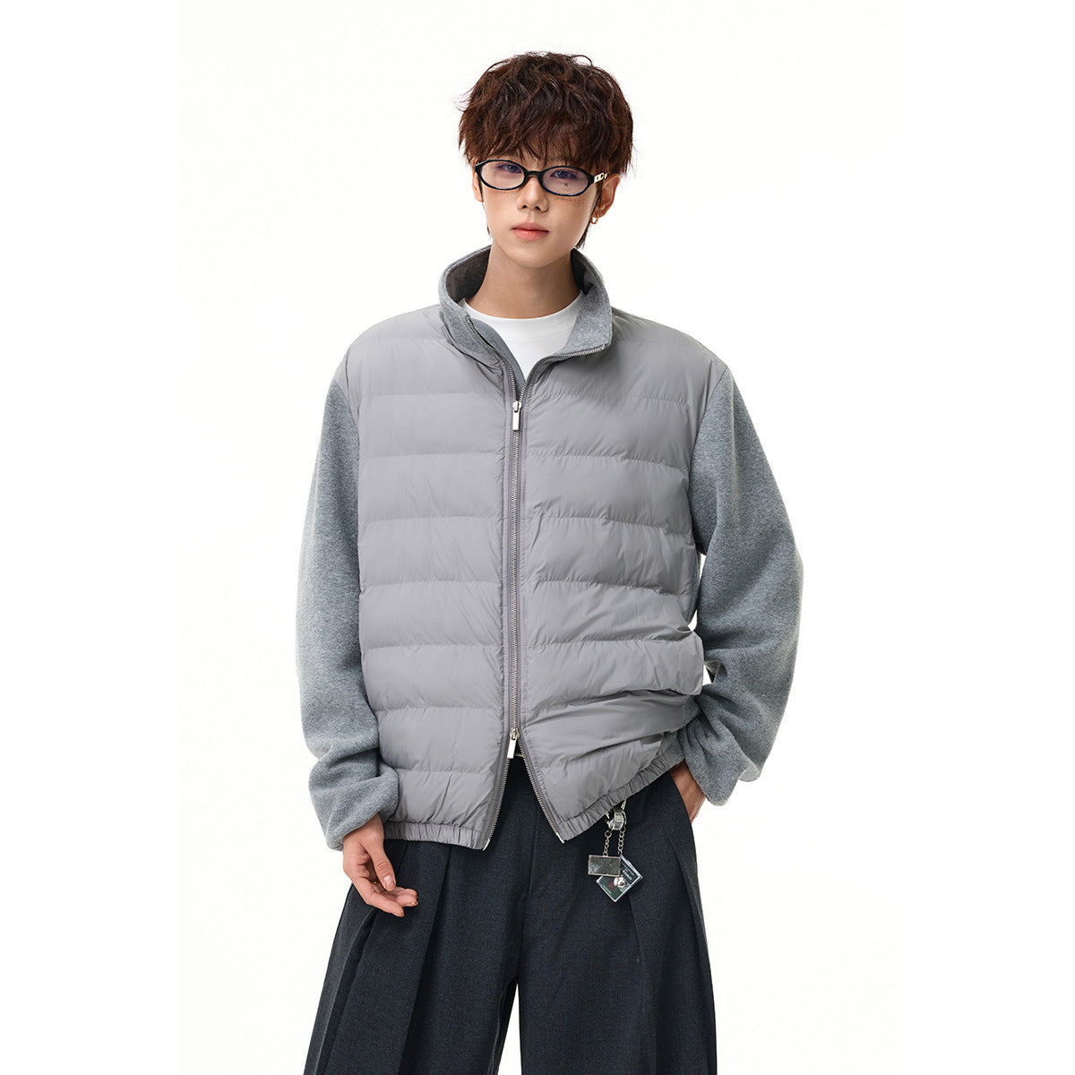 Model wearing a light gray quilted zip jacket with heather gray sleeves and a raised collar.