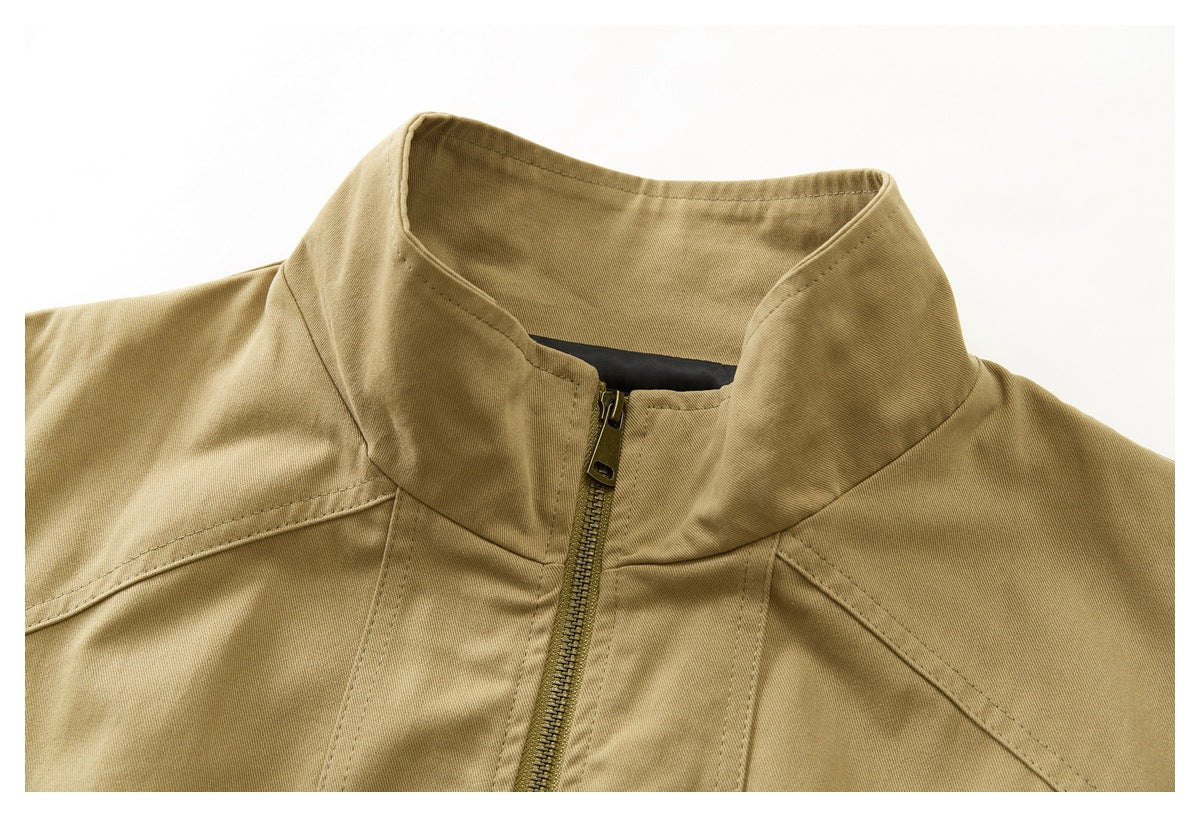 Close-up of a tan jacket's stand collar and front zipper.
